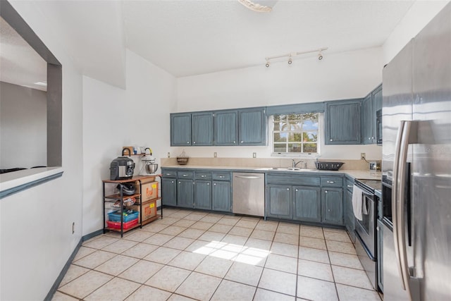 kitchen with stainless steel appliances, light tile patterned floors, and sink