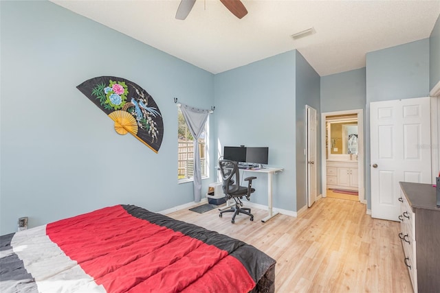 bedroom with light hardwood / wood-style floors, ceiling fan, and connected bathroom