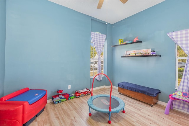 game room with hardwood / wood-style flooring and ceiling fan