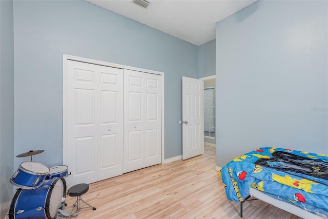 bedroom with a closet and light hardwood / wood-style floors