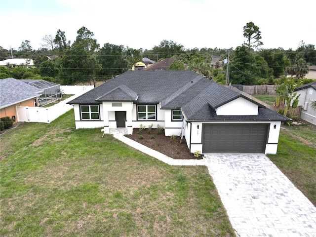 1081 Mccrory St, North Port, FL 34286 - view of front facade featuring a garage, a shingled roof, decorative driveway, and stucco siding