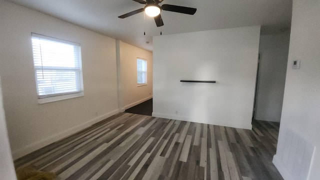 unfurnished room featuring ceiling fan and dark wood-type flooring