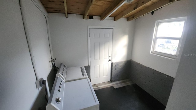 laundry room with brick wall and wood ceiling