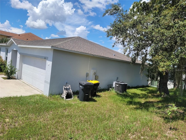 view of property exterior featuring a garage, cooling unit, and a lawn