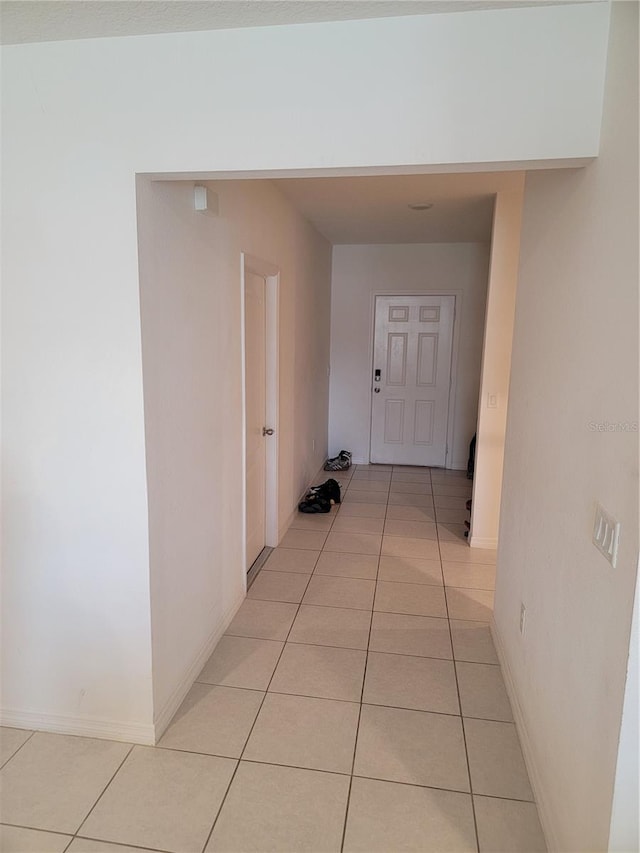 corridor with light tile patterned floors