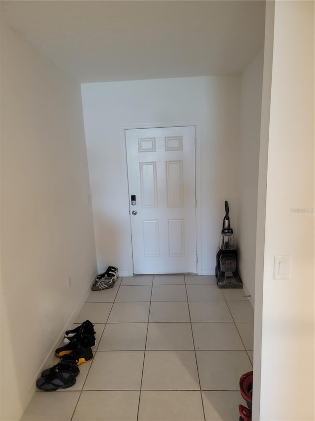 doorway with light tile patterned floors