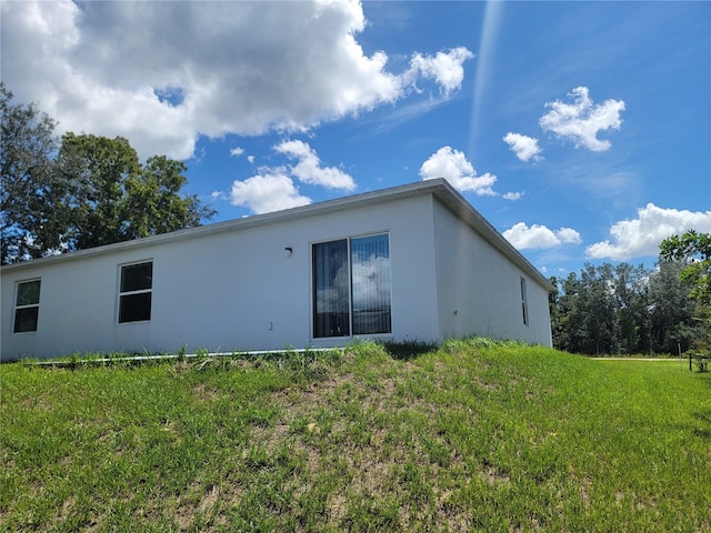 back of property featuring a lawn