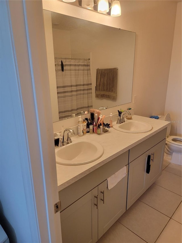 bathroom with toilet, vanity, a shower with shower curtain, and tile patterned flooring