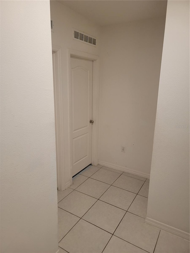 hall featuring light tile patterned flooring