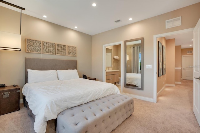 carpeted bedroom featuring ensuite bathroom