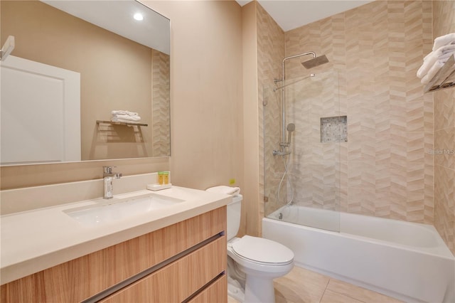 full bathroom featuring tile patterned flooring, vanity, toilet, and tiled shower / bath