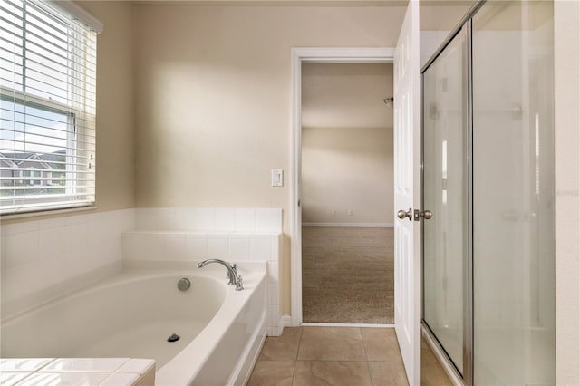 bathroom with tile patterned flooring and separate shower and tub