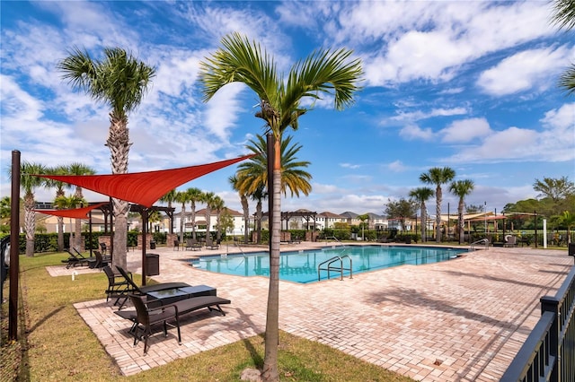 view of pool featuring a patio and a lawn