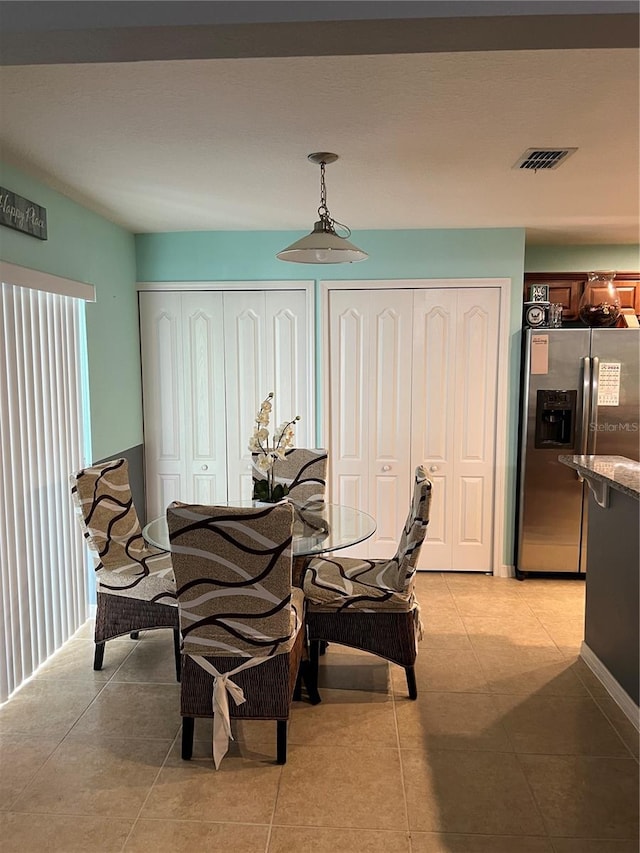 dining area with light tile patterned flooring