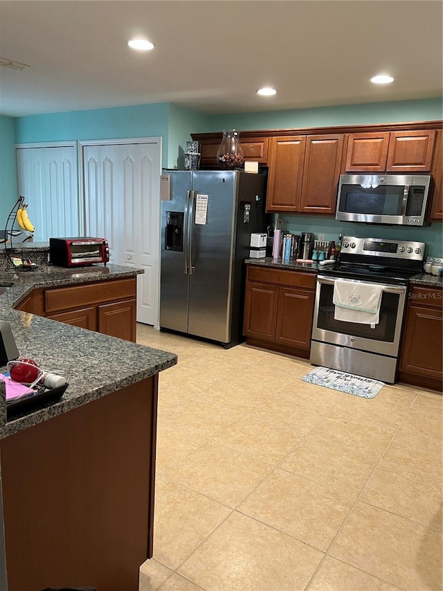 kitchen with light tile patterned floors and stainless steel appliances