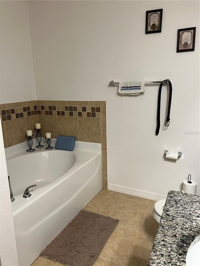 bathroom featuring a tub to relax in, tile patterned floors, and toilet