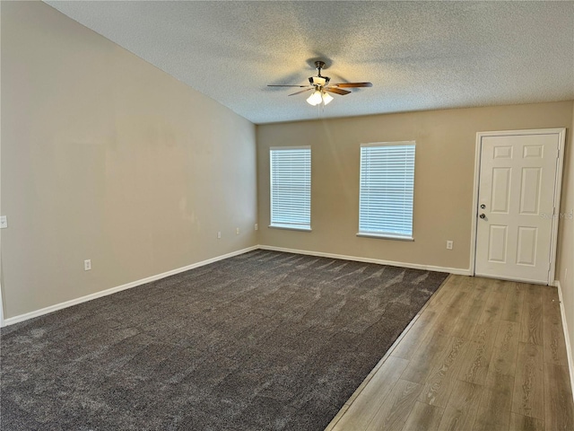 unfurnished room with a textured ceiling, hardwood / wood-style flooring, and ceiling fan