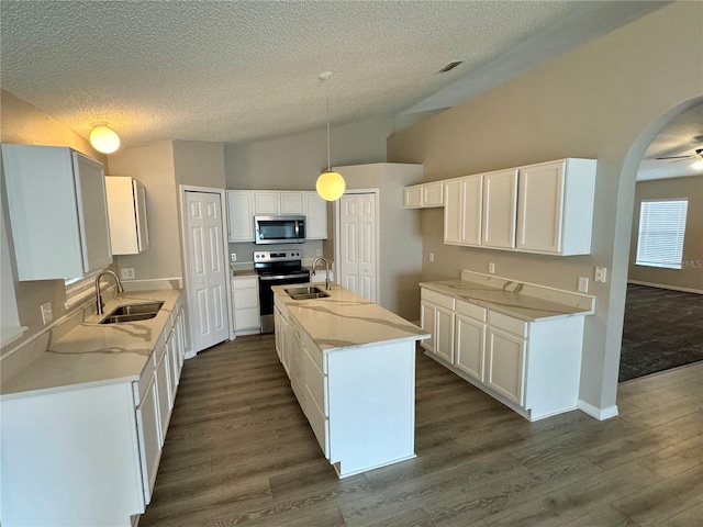 kitchen featuring white cabinets, sink, a center island with sink, and stainless steel appliances