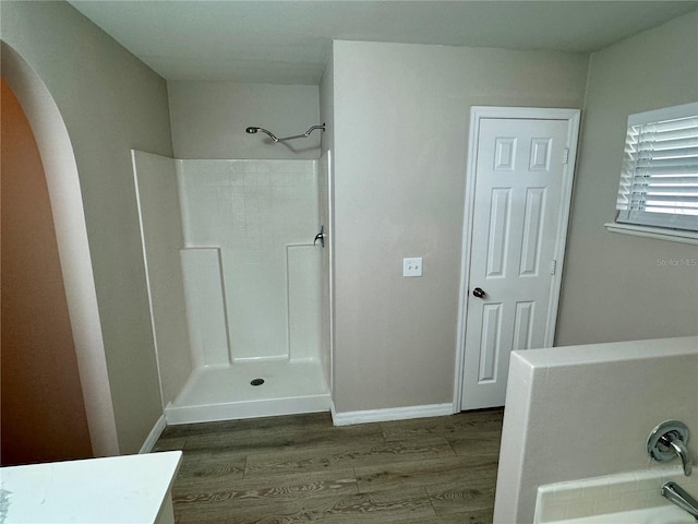 bathroom with hardwood / wood-style flooring, vanity, and independent shower and bath