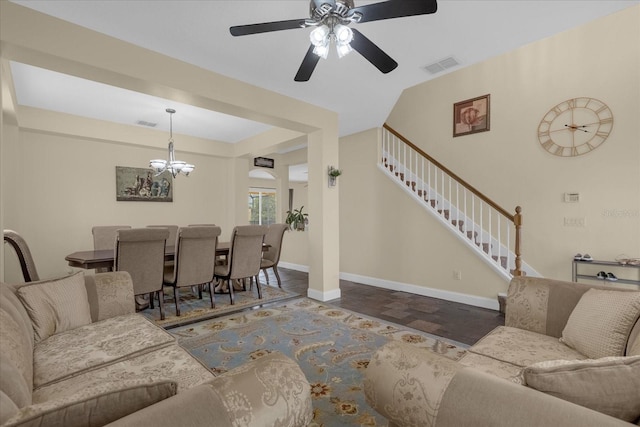 living room featuring ceiling fan with notable chandelier