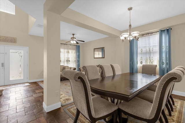 dining space featuring ceiling fan with notable chandelier