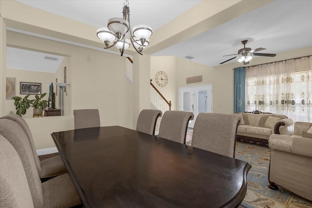 dining room with lofted ceiling and ceiling fan with notable chandelier