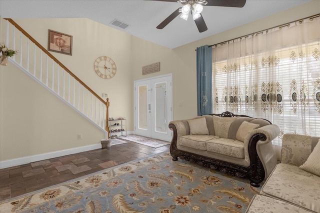 living room with a towering ceiling and ceiling fan