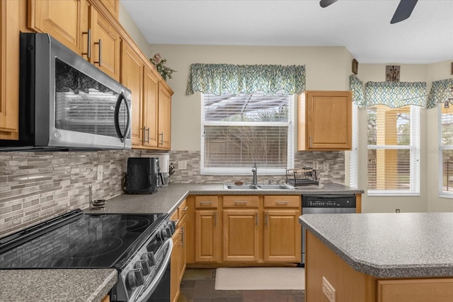 kitchen featuring a healthy amount of sunlight, sink, appliances with stainless steel finishes, and tasteful backsplash