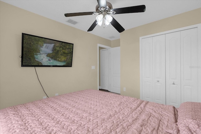 carpeted bedroom with ceiling fan and a closet