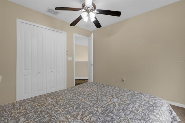 unfurnished bedroom with ceiling fan, a closet, and carpet