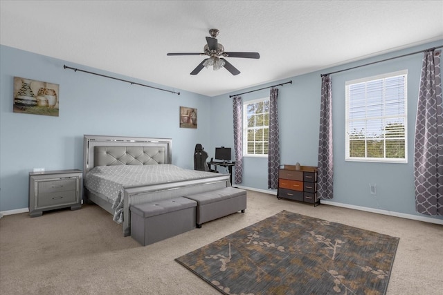 carpeted bedroom with multiple windows, ceiling fan, and a textured ceiling