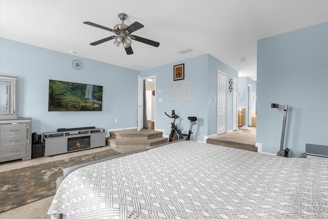 bedroom featuring light colored carpet and ceiling fan