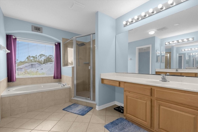 bathroom with tile patterned flooring, vanity, and separate shower and tub