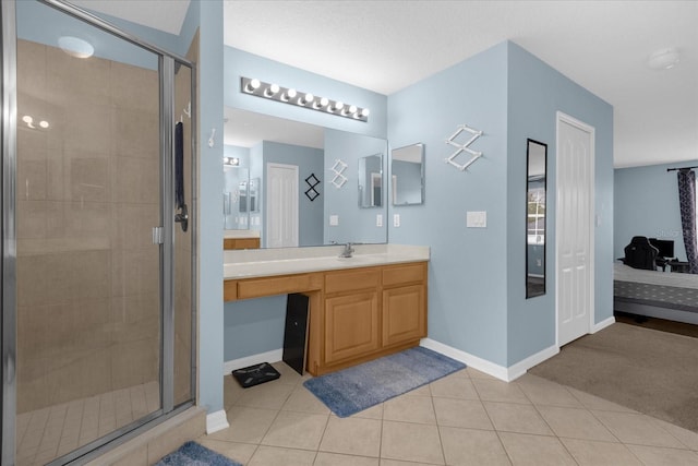 bathroom with tile patterned flooring, vanity, and a shower with door