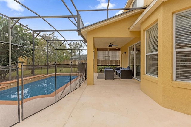 view of swimming pool featuring ceiling fan, a lanai, an outdoor living space, and a patio