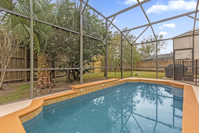 view of pool featuring a lanai and a lawn