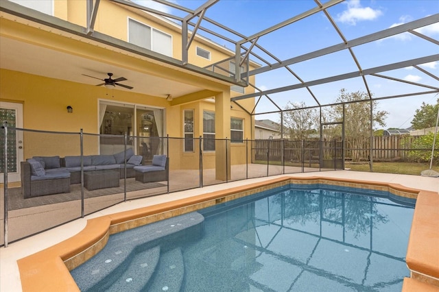 view of swimming pool with outdoor lounge area, glass enclosure, ceiling fan, and a patio