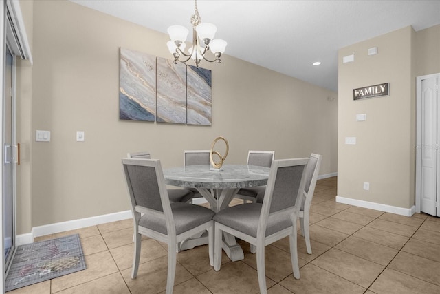 dining area featuring light tile patterned floors and a notable chandelier