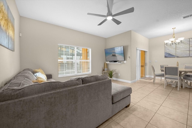 living room featuring ceiling fan with notable chandelier and light tile patterned floors