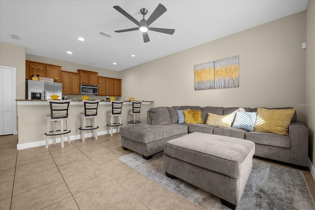 tiled living room featuring ceiling fan