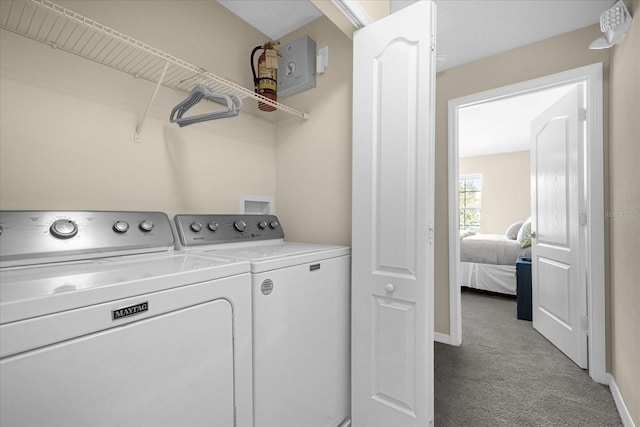 laundry area with washing machine and dryer and light carpet