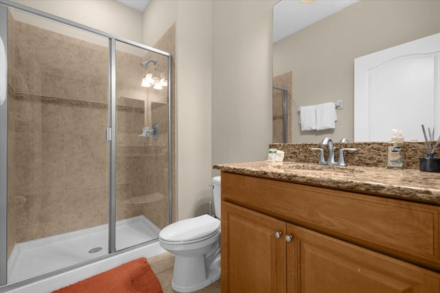 bathroom with tile patterned flooring, vanity, toilet, and an enclosed shower