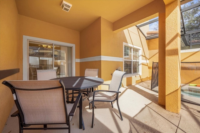 8962 Cuban Palm Rd, Kissimmee, FL 34747 - view of patio featuring outdoor dining space and glass enclosure