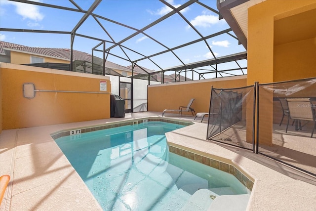 view of swimming pool featuring glass enclosure and a patio