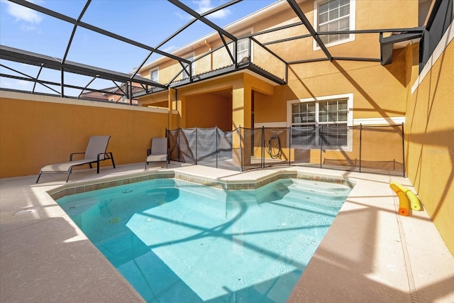 view of swimming pool featuring a patio area and a lanai