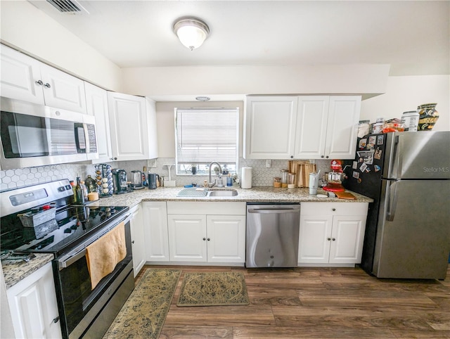 kitchen featuring white cabinetry, sink, dark hardwood / wood-style floors, and appliances with stainless steel finishes