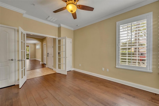 spare room with ornamental molding, french doors, hardwood / wood-style floors, and ceiling fan