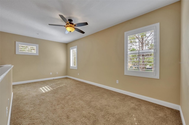 empty room featuring carpet flooring and ceiling fan