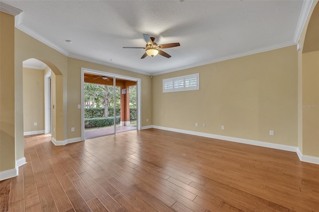 unfurnished room with ornamental molding, light hardwood / wood-style flooring, a textured ceiling, and ceiling fan