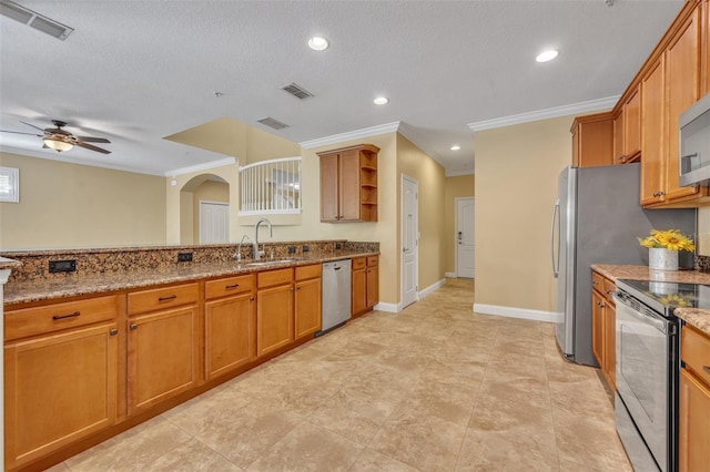 kitchen featuring sink, light stone counters, appliances with stainless steel finishes, a textured ceiling, and crown molding